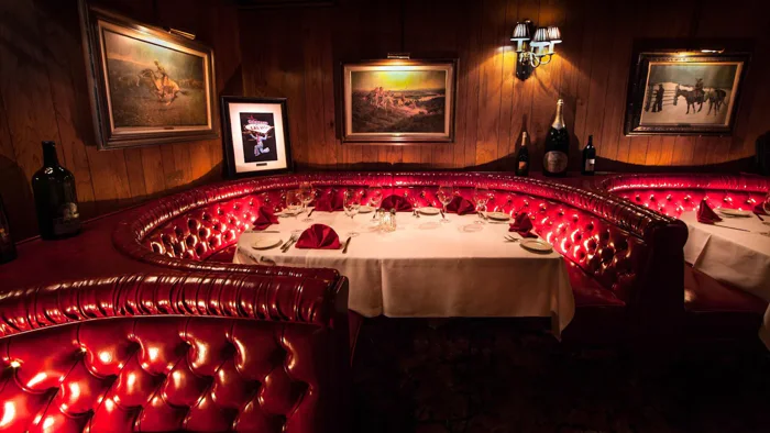 Red leather booths and white tablecloths in the Golden Steer dining room